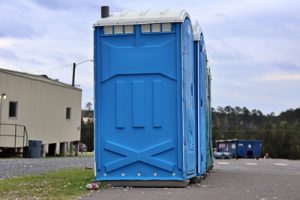 deluxe porta potty next to an office container